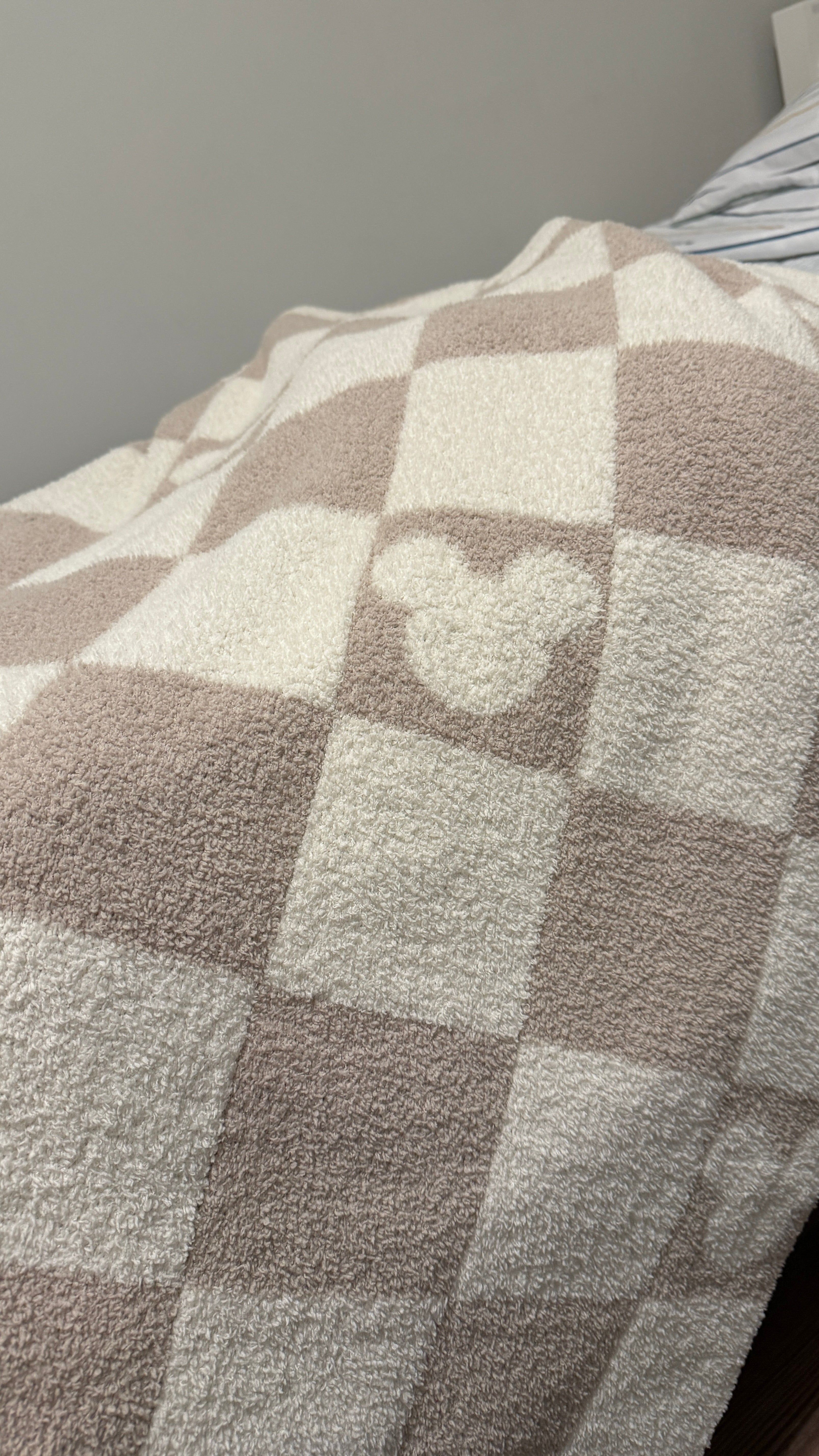 Checkered blanket with a Mickey head design on a gray background